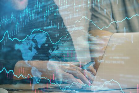 Forex graph with businessman typing on computer in office on background. Concept of analysis. Double...
