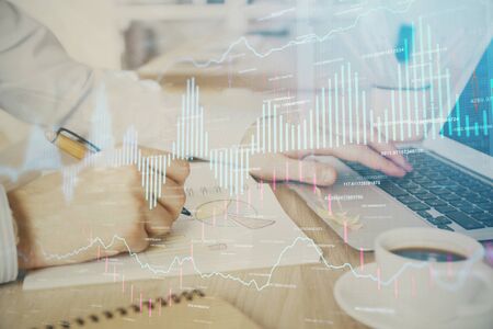 Multi exposure of stock market graph with man working on laptop on background. Concept of financial analysis.の写真素材