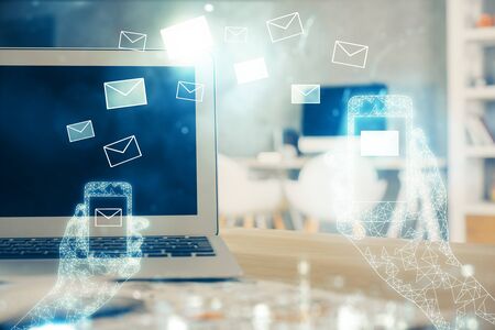 Desktop computer background in office and flying envelops hologram drawing. Multi exposure. Electronic mail concept.の写真素材