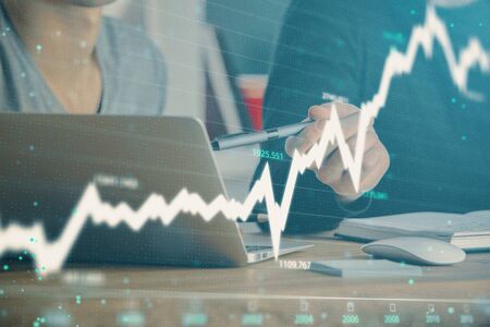 Forex graph with businessman typing on computer in office on background. Concept of analysis. Double...