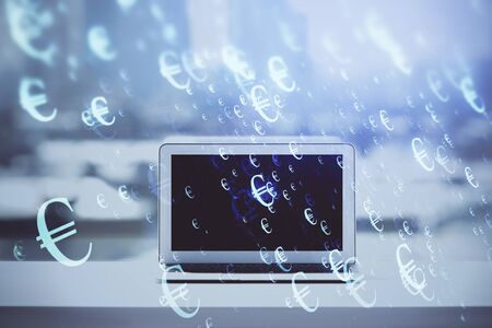 Forex graph hologram on table with computer background. Multi exposure. Concept of financial markets.の写真素材