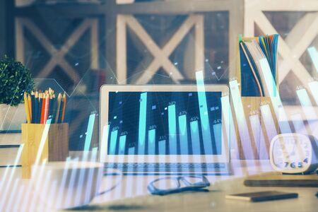 Double exposure of forex chart and work space with computer. Concept of international online trading.の写真素材