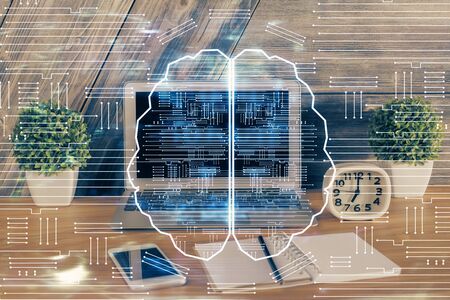 Multi exposure of work table with computer and brain hologram. Brainstorm concept.