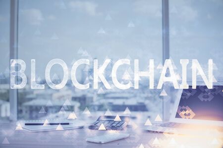 Double exposure of blockchain theme hologram and table with computer background. Concept of bitcoin crypto currency.の写真素材