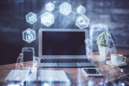 Computer on desktop in office with technology theme hologram. Multi exposure. Tech concept.の写真素材