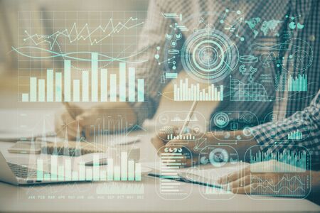 Multi exposure of forex chart with man working on computer on background. Concept of market...