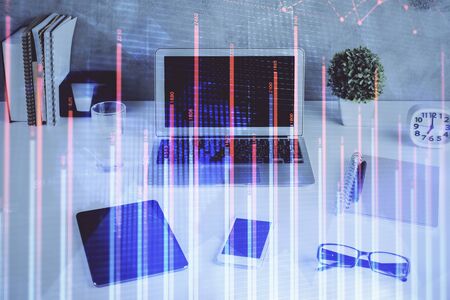 Stock market chart hologram drawn on personal computer background. Multi exposure. Concept of investment.の写真素材