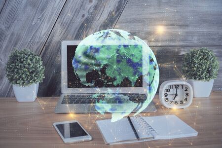 Computer on desktop with social network hologram. Multi exposure. Concept of international people connections.の写真素材