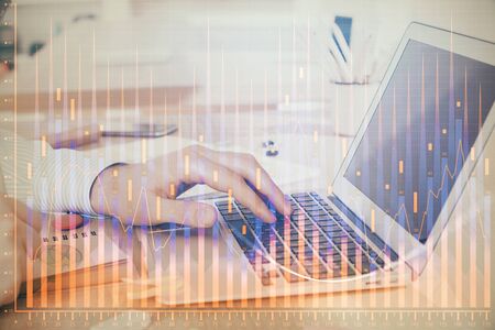Double exposure of stock market graph with man working on laptop on background. Concept of financial analysis.の写真素材