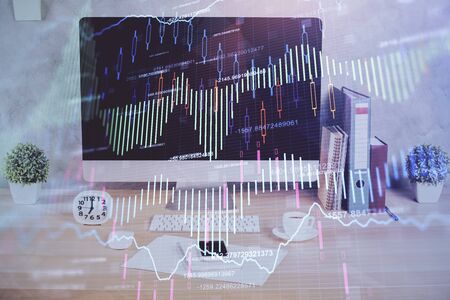 Forex graph hologram on table with computer background. Double exposure. Concept of financial markets.の写真素材