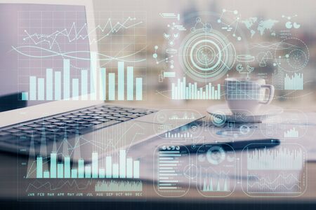 Forex graph hologram on table with computer background. Double exposure. Concept of financial markets.の写真素材