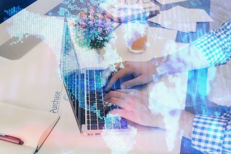 Multi exposure of graph with man typing on computer in office on background. Concept of hard work. Closeup.の写真素材