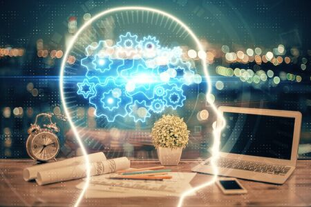 Multi exposure of work table with computer and brain hologram. Brainstorm concept.