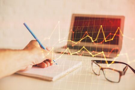 Multi exposure of man hands with stock market forex graph. Concept of research and analysis.