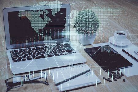 Double exposure of graph and financial info and work space with computer background. Concept of international online trading.の写真素材