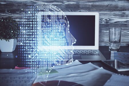 Double exposure of table with computer and brain hologram. Data innovation concept.