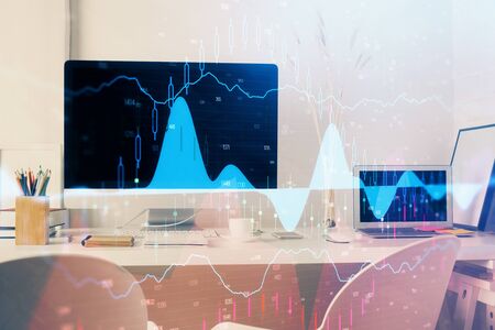 Forex market chart hologram and personal computer background. Double exposure. Concept of...