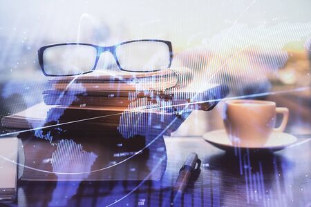 Financial graph hologram with glasses on the table background. Concept of business. Double exposure.の写真素材