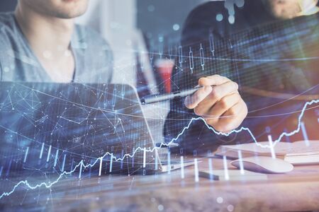 Forex graph with businessman typing on computer in office on background. Concept of analysis. Double...