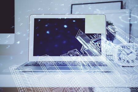 Desktop computer background in office and big town buildings hologram drawing. Double exposure. Smart city concept.の写真素材