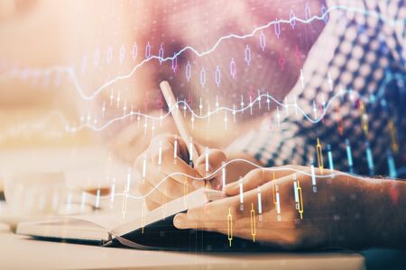 Multi exposure of two men planing investment with stock market forex chart background. Concept of...