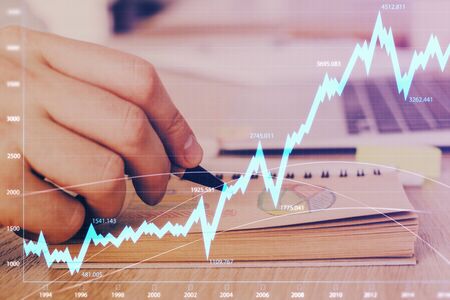 Multi exposure closeup hands with stock market forex graph. Concept of research and analysis.の写真素材