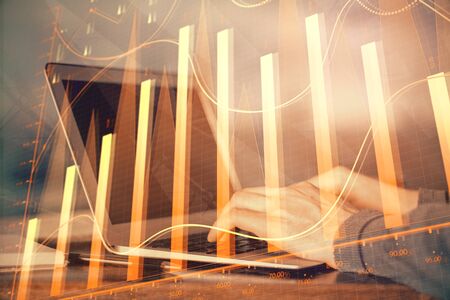 Double exposure of stock market graph with man working on laptop on background. Concept of financial analysis.の写真素材