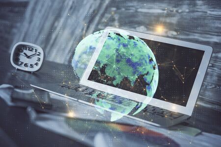 Computer on desktop with social network hologram. Multi exposure. Concept of international people connections.の写真素材