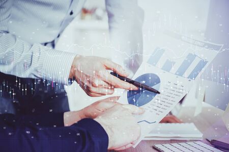 Financial trading graph double exposure with man desktop background. Concept of success.の写真素材
