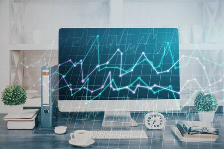 Forex graph hologram on table with computer background. Double exposure. Concept of financial...