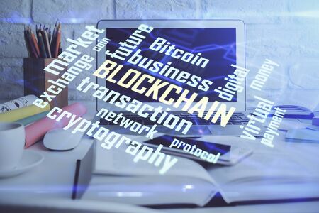 Multi exposure of blockchain and crypto economy theme hologram and table with computer background. Concept of bitcoin cryptocurrency.の写真素材