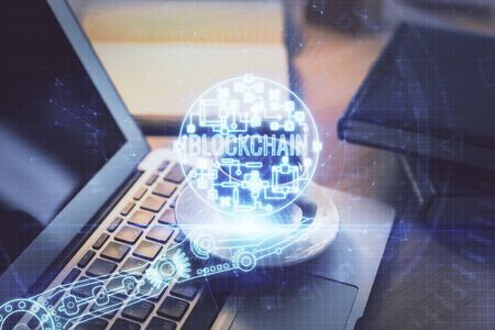 Multi exposure of blockchain and crypto economy theme hologram and table with computer background....