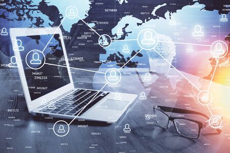 Computer on desktop with social network hologram. Multi exposure. Concept of international people...