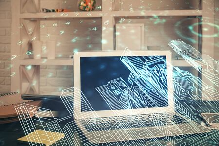 Desktop computer background in office and big town buildings hologram drawing. Double exposure. Smart city concept.の写真素材