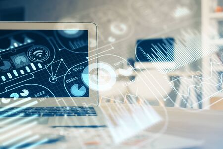 Computer on desktop in office with technology theme hologram. Multi exposure. Tech concept.の写真素材