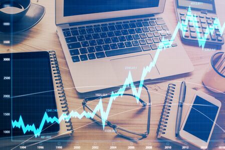 Double exposure of forex chart and work space with computer. Concept of international online...