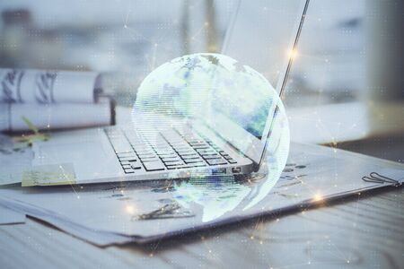 Computer on desktop with social network hologram. Multi exposure. Concept of international people connections.の写真素材