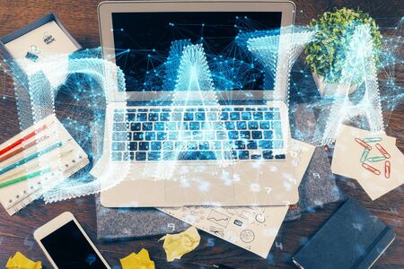 Double exposure of laptop computer and technology theme hologram. Concept of freelance work.