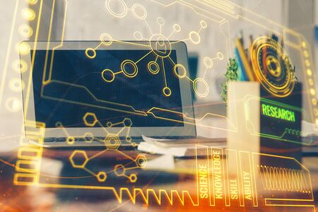 Double exposure of laptop computer and technology theme hologram. Concept of freelance work.の写真素材