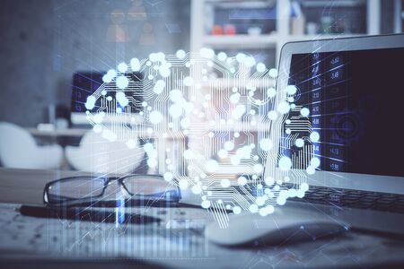 Double exposure of table with computer and brain hologram. Data innovation concept.