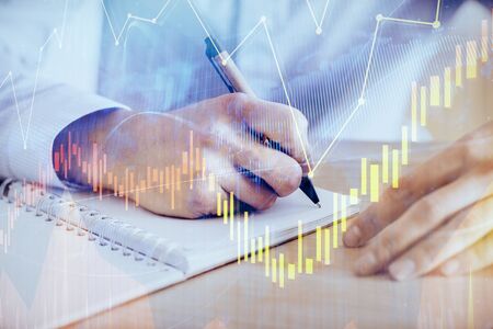 Multi exposure of man planing investment with stock market forex chart background. Concept of...