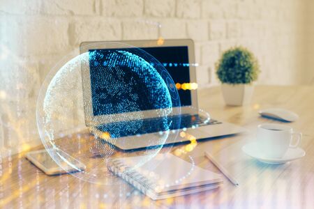Multi exposure of table with computer and world map hologram. International data network concept.の写真素材