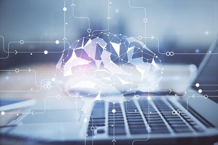 Double exposure of table with computer and brain hologram. Data innovation concept.