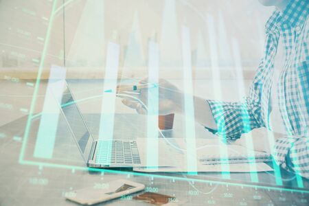 Multi exposure of stock market chart with man working on computer on background. Concept of financial analysis.の写真素材