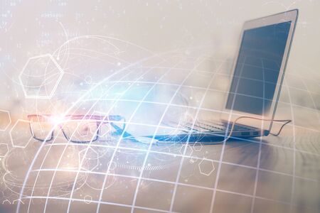 Multi exposure of table with computer and world map hologram. International data network concept.の写真素材