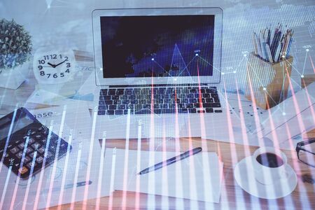 Forex market chart hologram and personal computer background. Multi exposure. Concept of investment.の写真素材
