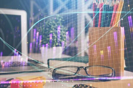 Financial chart hologram with glasses on the table background. Concept of business. Double exposure.の写真素材