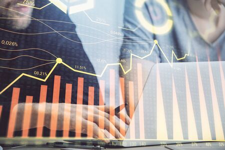 Forex graph with businessman typing on computer in office on background. Concept of analysis. Double...