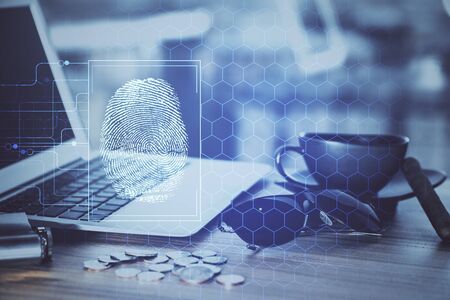 Computer on desktop in office with finger print drawing. Double exposure. Concept of business data...
