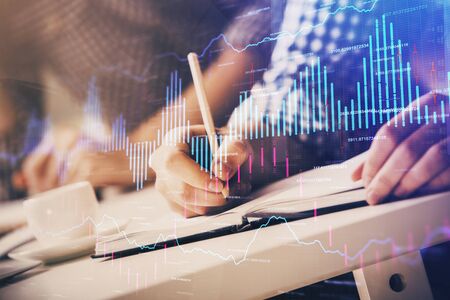 Multi exposure of two men planing investment with stock market forex chart background. Concept of...
